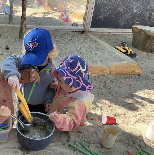 Children playing with sand toys in sand area