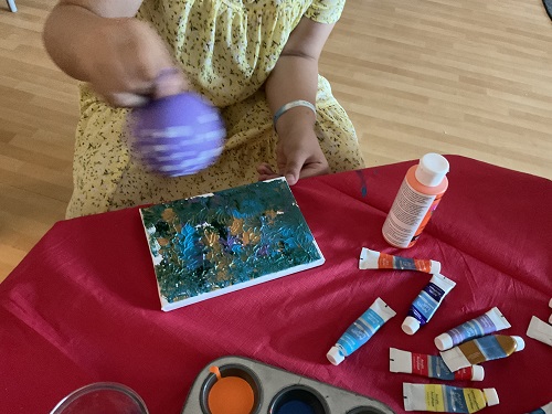 child painting with baloon