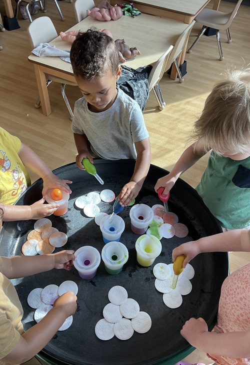 children exploring water colour pods