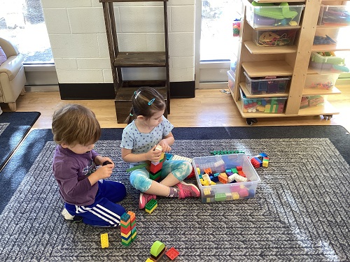 children building with lego blocks