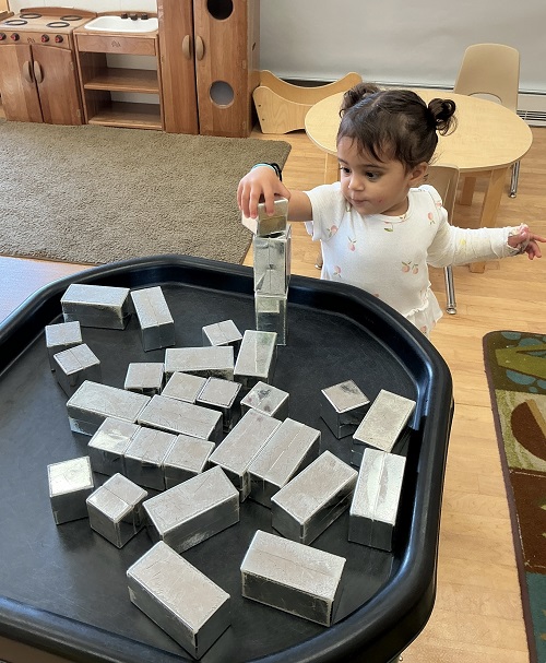 child stacking blocks