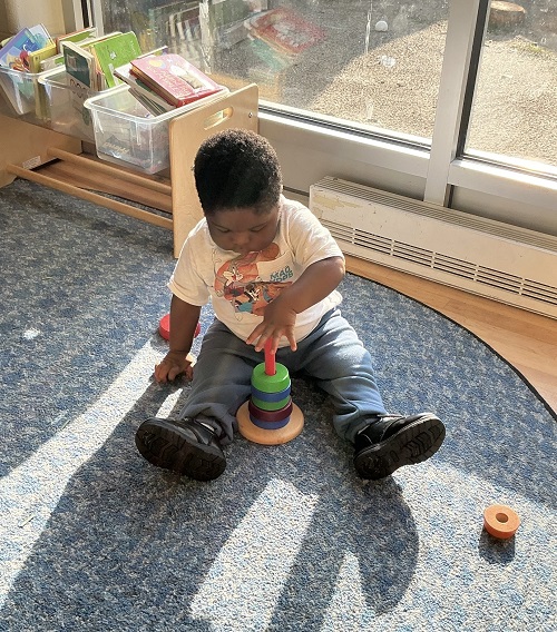 child playing with a stacking toy
