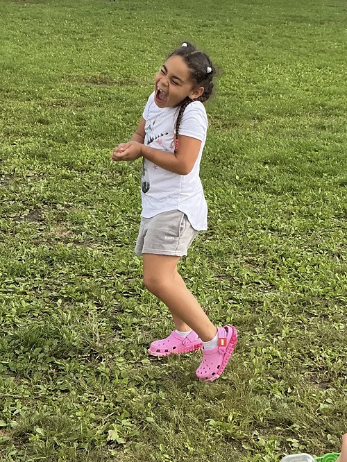 child excited they captured a rasshopper in their hands