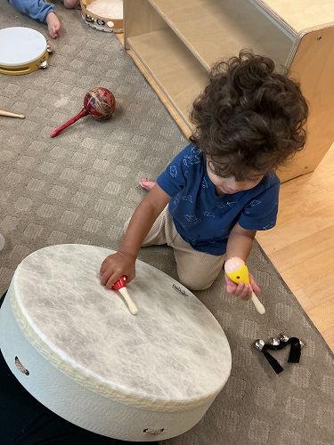 Infant child exploring with drums