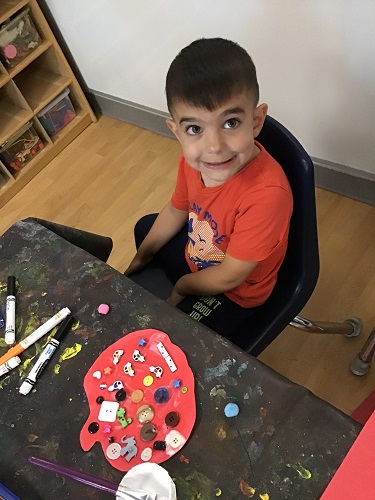 School aged child exploring with art materials
